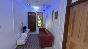 a living room with a couch and a door at BabaJay Family Home in Dar es Salaam