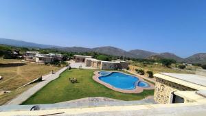 an aerial view of a house with a swimming pool at Sariska Kasba - A Village Resort in Tehla