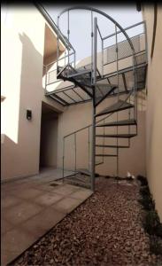 a stairway in a building with a spiral staircase at PINEDA DEL RIO in Patagones +16 photos