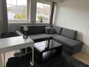 a living room with a couch and a table at Topview in Hammerfest