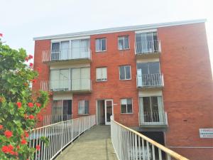 a red brick building with a walkway in front of it at View Street Vista location parking and views in Sandy Bay