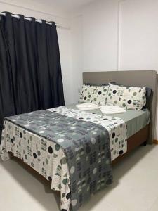a bed with polka dot sheets and pillows at Cabo Frio - Temporadas in Cabo Frio