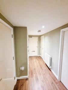 an empty living room with a hard wood floor at Your Riverside Home 3 with Private balcony in Woolwich