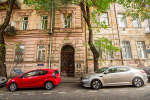 two cars parked in front of a building at Center Apartment 3 Rooms in Tbilisi City