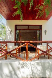 a room with a table and chairs in front of a building at Salida Beach in Kizimkazi