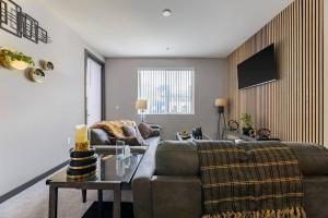 a living room with a couch and a table at Private, Modern Luxury 2 Bd/ 2 Ba in Santa Ana