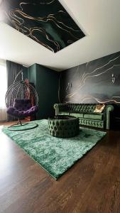 a living room with a couch and a green rug at VIP квартира подобово in Luts'k