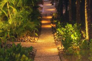 a pathway in a garden at night with lights at Punta Islita, Autograph Collection in Islita