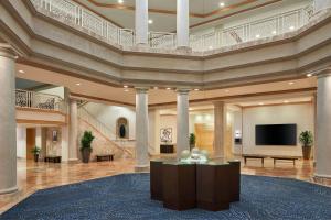 a large lobby with columns and a flat screen tv at Westfields Marriott Washington Dulles in Chantilly