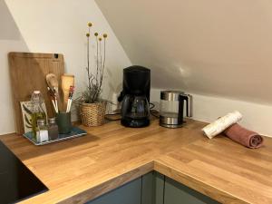 a kitchen counter with a coffee maker on a wooden counter top at Inn Het Nest in Amsterdam