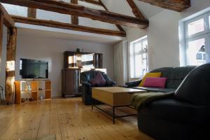 a living room with a couch and a tv at Omas Linde in Brandenburg an der Havel