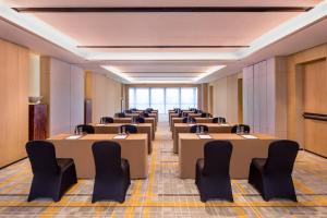 a row of tables and chairs in a room at Courtyard by Marriott Shanghai Hongqiao in Qingpu