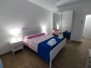 a bedroom with a large bed and a mirror at Holiday Home Ischia in Ischia Town