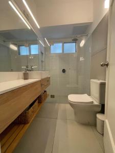 een witte badkamer met een toilet en een wastafel bij Quaint, cozy apart in best location in Montevideo