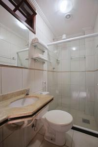 y baño con aseo, lavabo y ducha. en Estúdio com Ar Refrigerado a 300 m Praia, en Cabo Frío