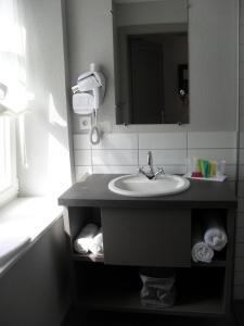 a bathroom with a sink and a mirror at Hôtel du Haut Koenigsbourg- entre vignes et château in Thannenkirch +46 photos
