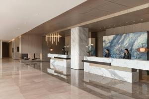 a lobby of a building with people in the lobby at Courtyard by Marriott Shenzhen Northwest in Bao'an