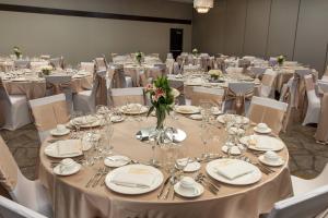 a room filled with tables and chairs with silverware at Courtyard by Marriott Lafayette in Lafayette +29 photos