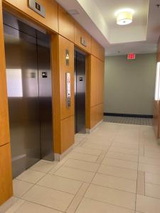 an empty hallway with elevators in a building at Luxury Condo with city skyline views - Mins to YYZ in Toronto