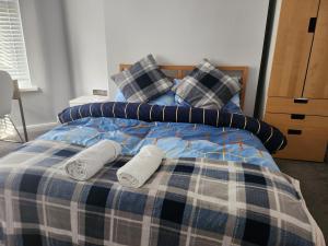 a bed with two pillows and two towels on it at Leopold House Liverpool in Liverpool