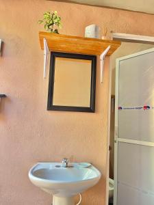 a bathroom with a sink and a mirror at Casa Lol-cab Hostal in Valladolid +19 photos