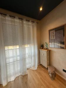 a room with a large window with white curtains at Suite Emilia in SantʼIlario dʼEnza