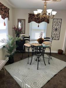 a dining room with a table and chairs on a rug at Home Sweet Home in Columbia