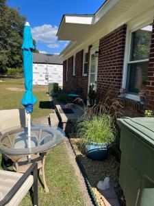 a blue umbrella sitting on a table next to a house at Home Sweet Home in Columbia