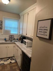 a kitchen with white cabinets and a microwave on the counter at Home Sweet Home in Columbia