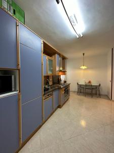 a large kitchen with a table in the background at Habitación matrimonial cómoda Av Santa Ana 25 3d in Tudela