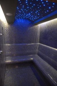 a bathroom with a shower with blue lights on the ceiling at Berjer Boutique Hotel & Spa in Istanbul