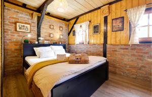 a bed in a room with a brick wall at Amazing Home In Gornji Daruvar With House A Panoramic View in Daruvar