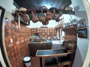 a kitchen with a table and some pots and pans at Libélula Cabaña- Alojamiento rural in Duitama