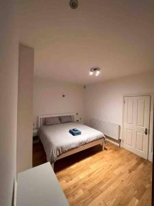 a bedroom with a bed and a wooden floor at 2 bed garden flat West Dulwich FREE STREET PARKING in London