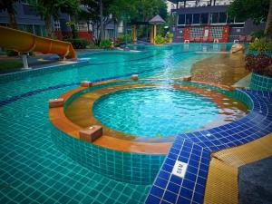 a swimming pool with a slide in the middle at The Casa Blanca Room condo in Hua Hin