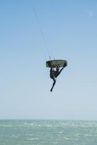 Eine Person ist in der Luft über dem Meer in der Unterkunft Palaa Mayapo Ecolodge in Mayapo