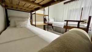 a bedroom with two beds and a window at Casa Dona Hilda Blumenau in Blumenau