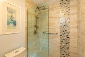 a shower with a glass door in a bathroom at Kauhale Makai 122 in Kihei +20 photos