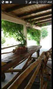 a wooden bench with potted plants on top of it at Complejo Aguas de Reposo CASA DE CAMPO in San Rafael