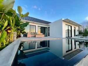 a swimming pool in front of a house at Private pool villa Siargao La residence in General Luna