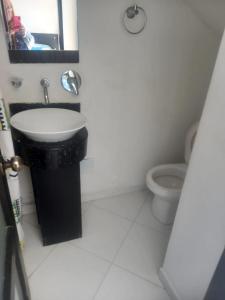 a bathroom with a sink and a toilet at Penthouse Rodadero Norte in Gaira