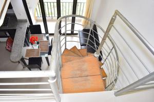 a spiral staircase with a wooden door in a house at Penthouse Rodadero Norte in Gaira