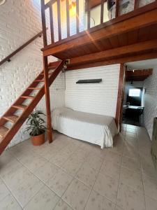 a bedroom with a bed and a staircase at Casa MAR in Playa Unión