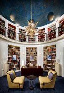 a library with two chairs and a table and a chandelier at Fairmont San Francisco in San Francisco