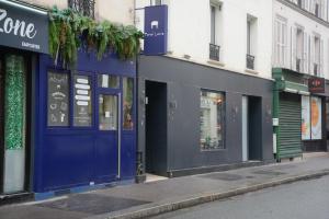 a row of store fronts on a city street at Enjoy Hostel in Paris