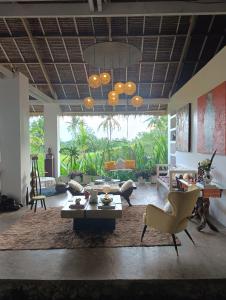 a living room filled with furniture and a large window at The Living Room Siargao in General Luna