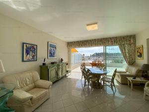 a living room with a couch and a table at Appartement climatisé face mer, avec piscine et parking, Cavalaire-sur-Mer - FR-1-100-320 in Cavalaire-sur-Mer
