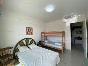 a bedroom with a bed and a bunk bed at Appartement climatisé face mer, avec piscine et parking, Cavalaire-sur-Mer - FR-1-100-320 in Cavalaire-sur-Mer +14 photos