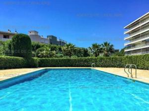 a swimming pool in the middle of a building at Appartement climatisé face mer, avec piscine et parking, Cavalaire-sur-Mer - FR-1-100-320 in Cavalaire-sur-Mer