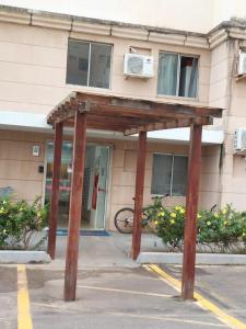 a wooden structure in front of a building at A FELICIDADE MORA AQUI in São Luís